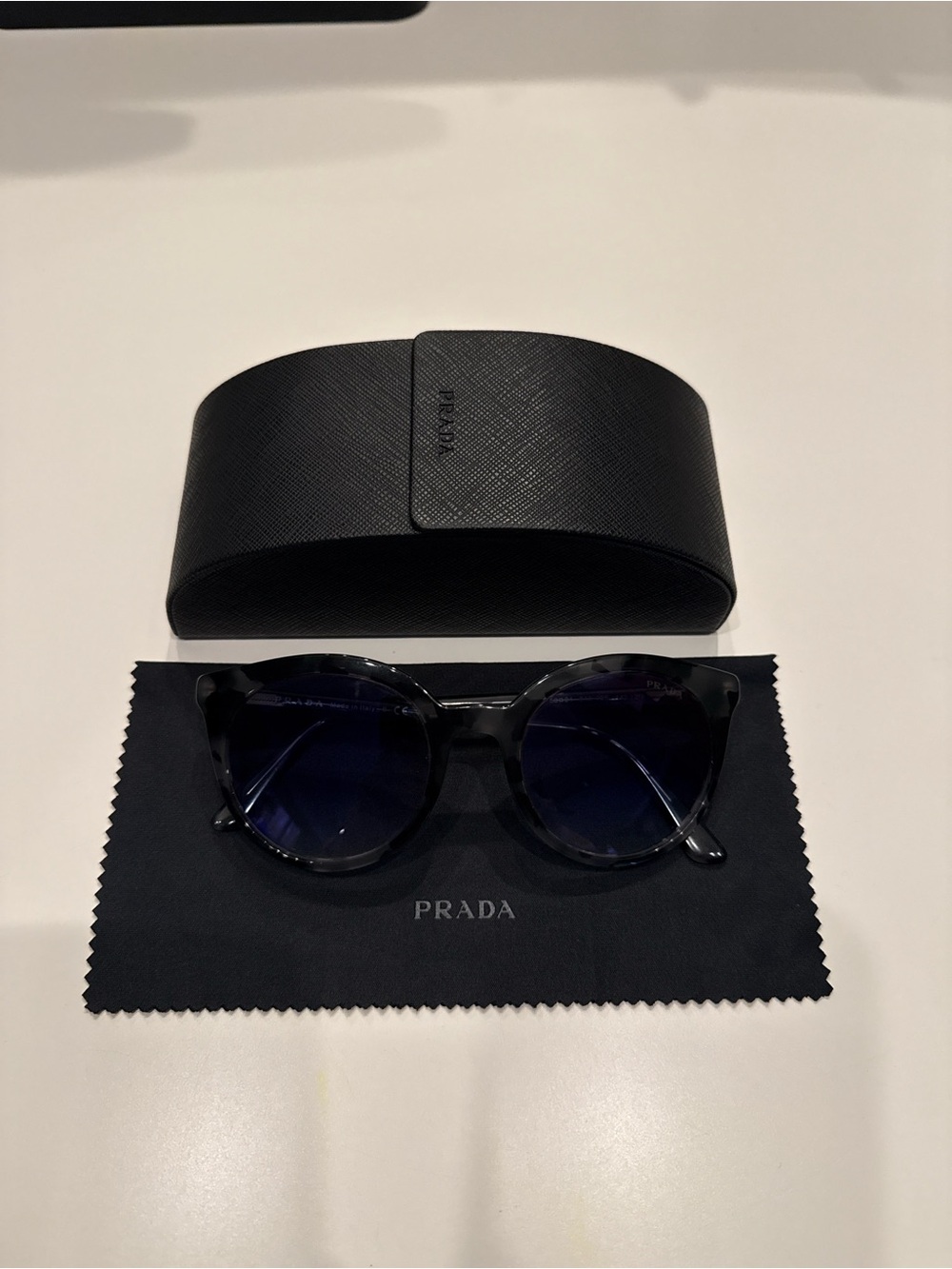 Prada women’s Black Round Sunglasses with Dark Blue Lenses